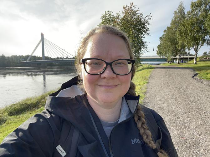 Kuvassa Jaana Sorvali viheralueella. Taustalla näkyy Rovaniemen tunnettu silta.