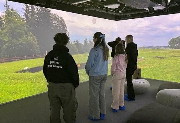 Young people view a rural landscape in a virtual space