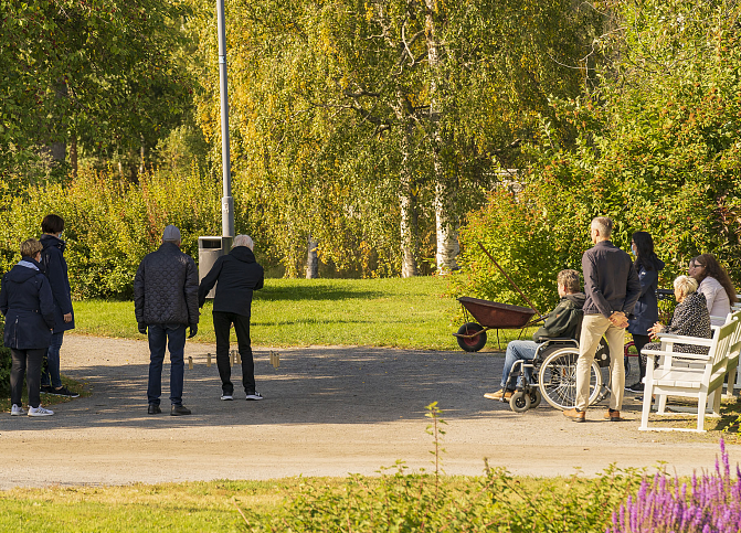 Kuvassa näkyy ihmisiä viettämässä aikaa Hupisaarilla.